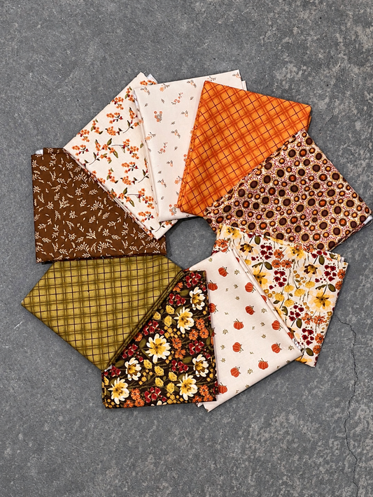 Bountiful 9-Piece Fat Quarter Bundle by Sandy Gervais for Riley Blake Designs, featuring colorful fabric squares in natural light.