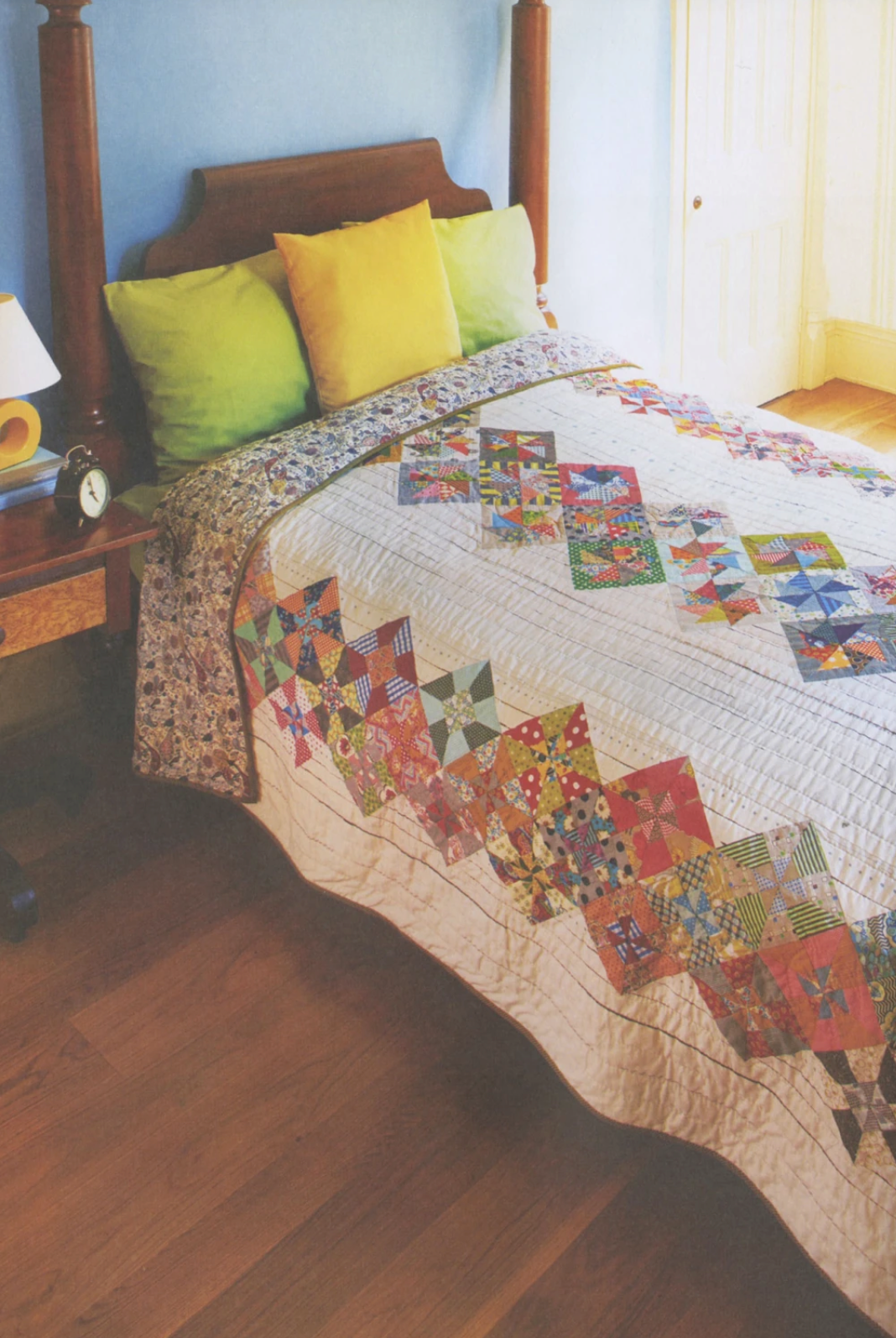 Vibrant quilt from Jen Kingwell's Quilt Lovely Book, featuring colorful patchwork and detailed stitching on a cozy quilt.
