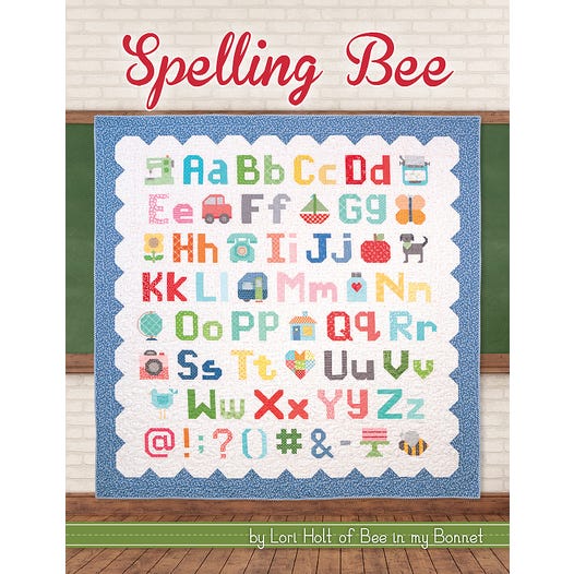 Spelling Bee Quilt Book by Lori Holt from It's Sew Emma, featuring colorful quilt patterns and sewing project ideas.